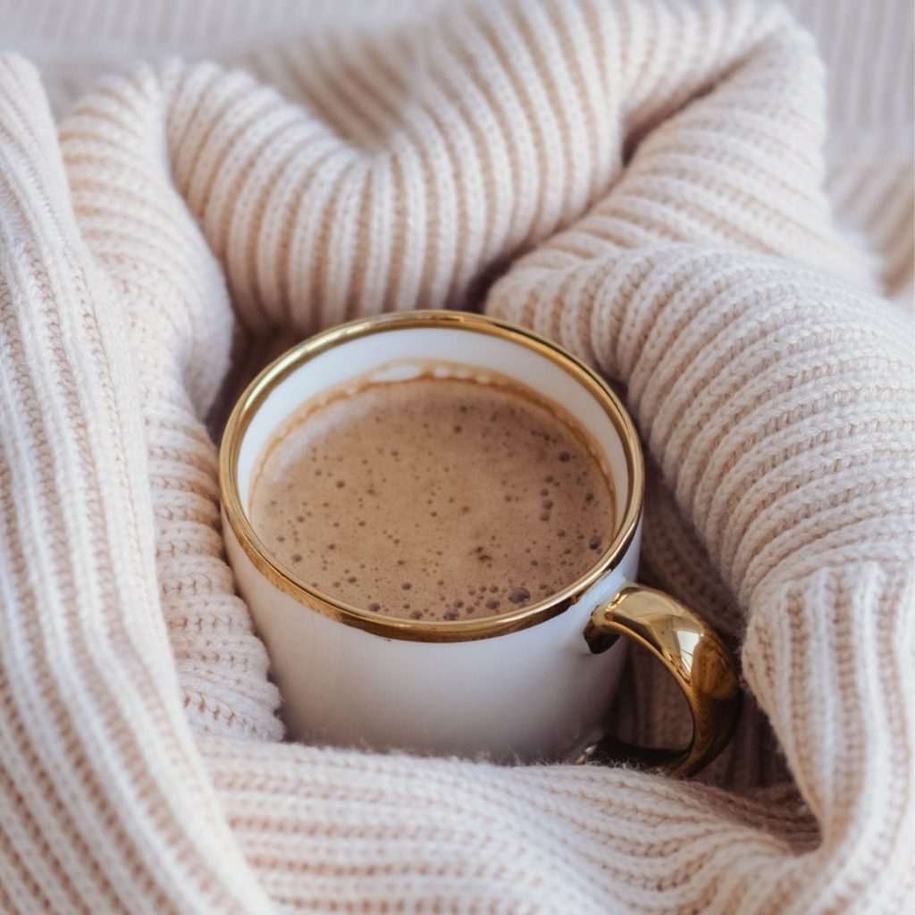 Cozy cup of cocoa in soft blanket