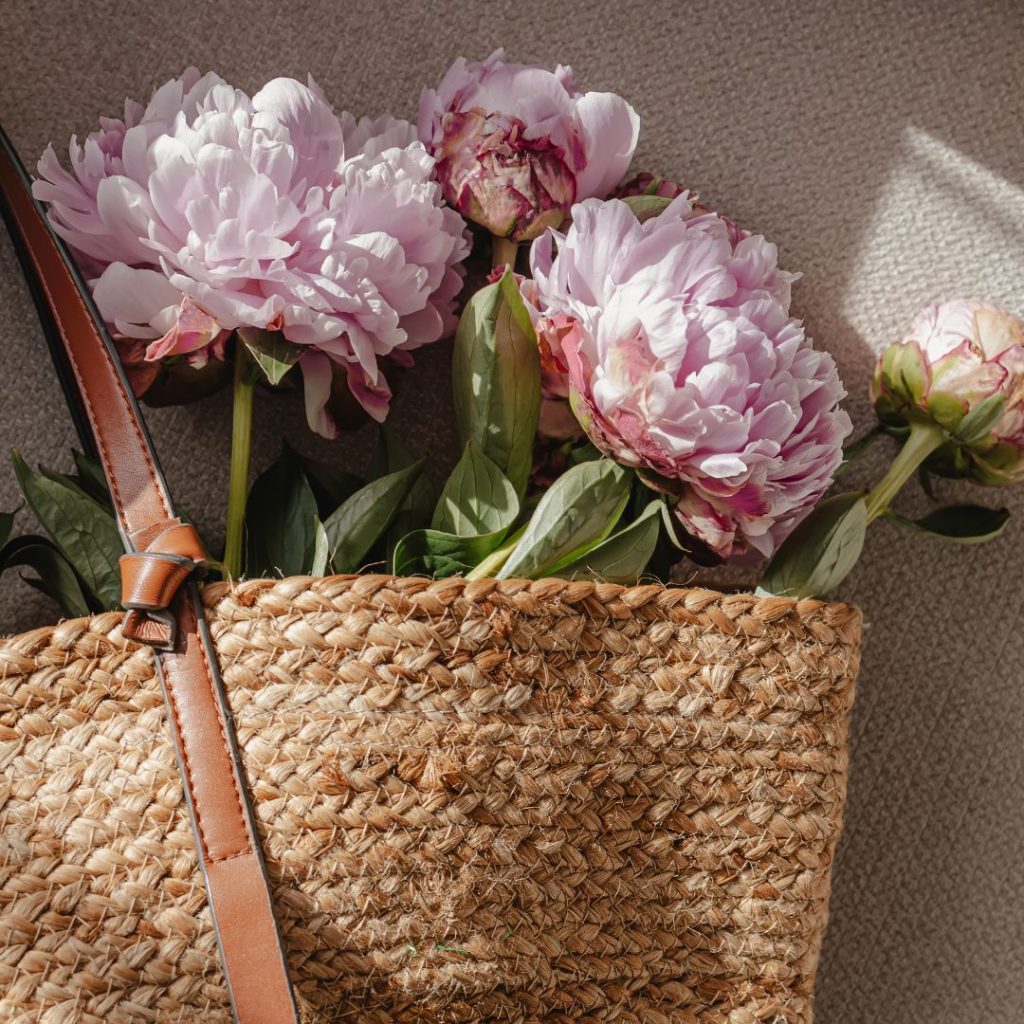 Fresh pink peonies in woven basket