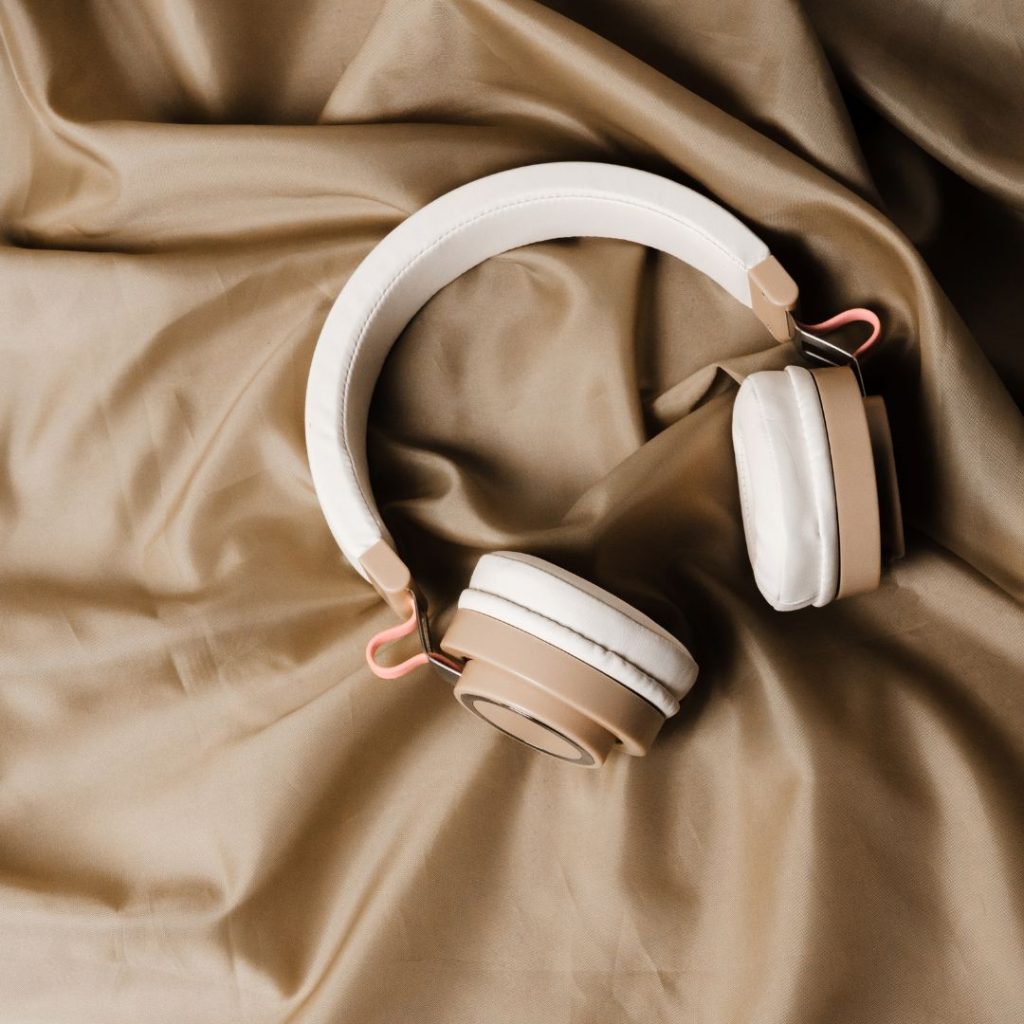 Beige headphones on smooth silk fabric